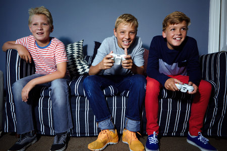 Children, controller and video gaming with friends on sofa in living room of home together for fun....