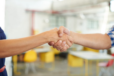 Handshake, startup and hands of business people in office for meeting, recruitment and onboarding. Creative agency, hiring and workers with gesture for agreement, partnership and welcome for teamworkの写真素材