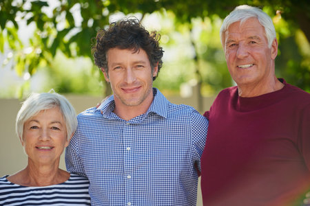 Portrait, elderly parents and son in backyard with smile, connection or bonding on summer break....