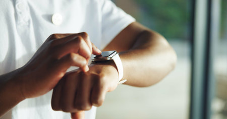 Hands, smart watch and tracking with physiotherapist man in clinic for rehabilitation progress. Fitness app, technology and time with person in therapy office for development, health or wellnessの写真素材