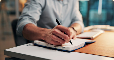 Hands, writing and notebook at startup for project, proposal or research article at media company. Person, writer or journalist with story planning, editing or checklist for report at creative agencyの写真素材