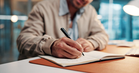 Hands, writing notes and book at startup with review, proposal or research for article at media company. Person, writer or journalist with planning story, editing and checklist at creative agencyの写真素材