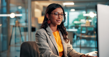 Night, media agency and woman with computer, reading and creative project with email. Person, evening and journalist in office, pc and article submission with publishing, copywriting and website blogの写真素材