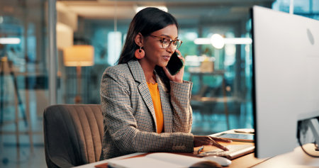 Business woman, smile and phone call with computer for chat, typing or contact source for story. Mobile, journalist and person in office with tech for communication, article publication and newsの写真素材