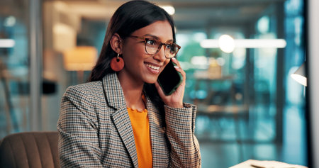 Business woman, smile and phone call in workplace for chat, update or contact source for story. Mobile, journalist and person in office for communication, article publication and news feedbackの写真素材