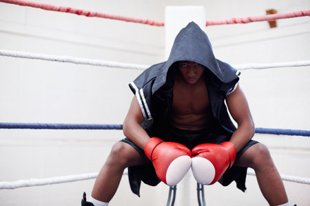 Black man, boxer and portrait in gym for workout, self defense exercise or mindset for fighting. Serious, prepare and african person or athlete for fitness, endurance or challenge in boxing ringの写真素材