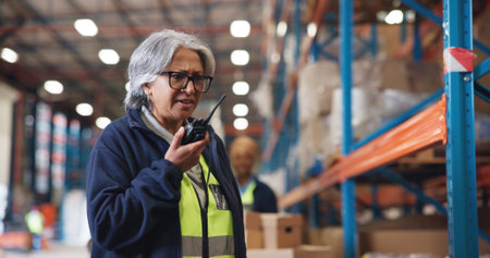 Radio, confused and logistics with woman in warehouse for shipping delay, supply chain and quality control. Export, inventory mistake and ecommerce contact with mature employee in factory for errorの写真素材