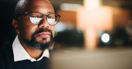 Computer, finance and night with business black man in office for portfolio or risk management....