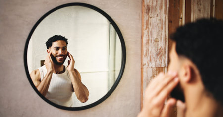 Happy man, grooming and hygiene with mirror in bathroom for morning routine or cosmetics in home....