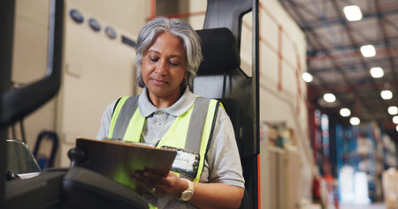 Writing, clipboard and forklift with woman in warehouse for shipping checklist, supply chain and quality control. Export, inventory manager and ecommerce supplier with mature employee for freightの写真素材