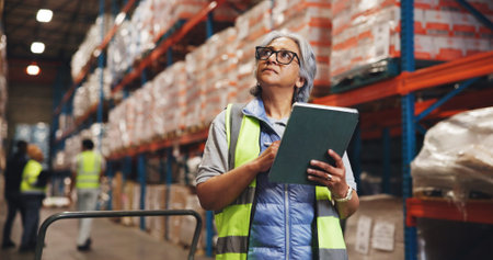 Distribution, tablet and woman in warehouse, thinking and email for shipping schedule. Mature...