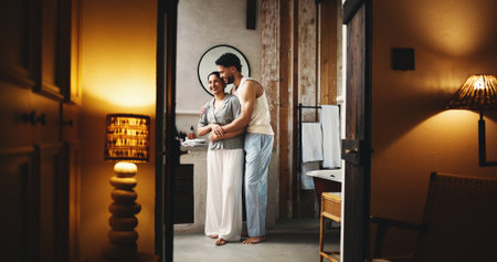 Couple, smile and hug in bathroom at hotel for weekend getaway, connection or bonding together. Happy, married people and embrace in lodge for healthy relationship, holiday or vacation accommodation.の写真素材