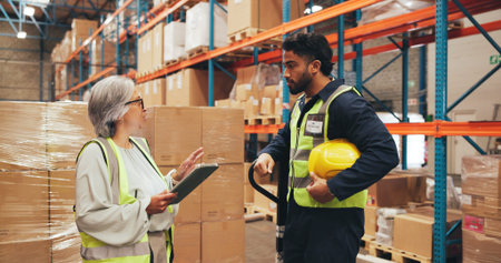 Supply chain, talking and people on tablet in warehouse for inspection, shipping and planning. Supervisor, distribution and workers in meeting for logistics, manufacturing and online inventoryの写真素材