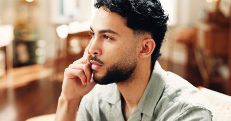 Home, thinking and man on sofa, remember and solution with decision, calm and thoughtful. Reflection, problem solving and person on couch, choice and planning for daily activity, options and memoryの写真素材