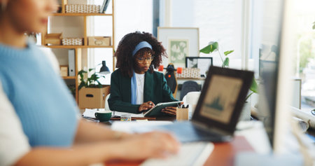 Woman, reading and scroll in office with tablet for data analysis, financial performance and results. Female person, coworking and research with tech for finance analytics, stats report and feedback.の写真素材