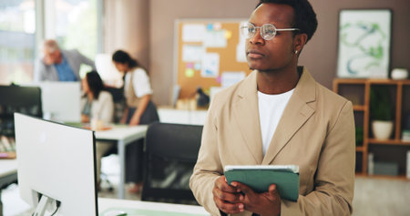 Thinking, marketing or man in office with tablet, industry research or ideas for company growth. Reflection, glasses or creative clerk in agency with tech, inspiration or planning for brand promotionの写真素材