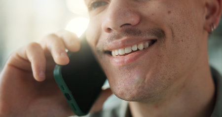 Man, mouth and smile in office with phone call for marketing discussion, campaign planning and feedback. Happy, person and contact with tech for advertising conversation, creative idea and update.の写真素材