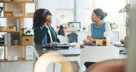 Media agency, talking and women in office, planning and teamwork with ideas, startup and support. Help, journalist and people with communication, creative or discussion with submission or publicationの写真素材