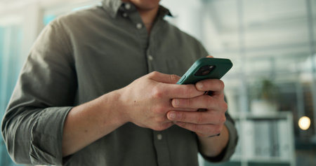 Typing, phone and hands of business man in office for account advisor, communication and contact. Portfolio report, online review and investor app with person in agency for connection and networkの写真素材