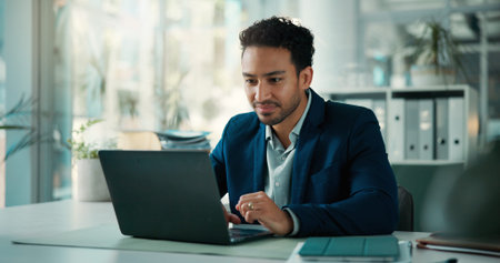 Business, man and laptop with reading in office for budget review, monitor market trends or email....