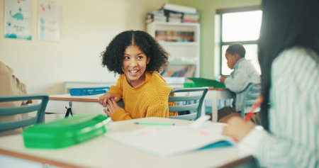 Cheating, exam and education with girl in classroom for essay plagiarism, quiz answers and gossip. Secret, academic pressure and study risk with children in school for scholarship and test helpの写真素材