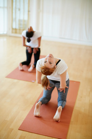 Women, friends and stretching for yoga in studio with fitness, flexibility and body balance. People,...