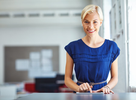 Journalist, portrait or woman in agency with tablet, experience or pride in media job. Happy, space or female person in newsroom with confidence, press or career growth in publishing industry.の写真素材