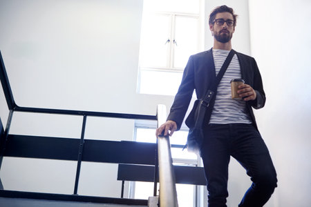 Journalist, walk or man with coffee on stairs, thinking or news investigation for local field research. Low angle, space or writer leave to find sources, insight or story inspirationの写真素材