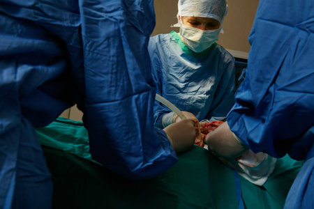 Surgery, doctor and people in operating room, healthcare and suction with emergency. Group, medical...