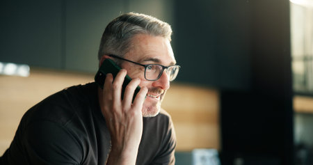 Communication, phone call and man with smile in kitchen, listening and conversation for networking....