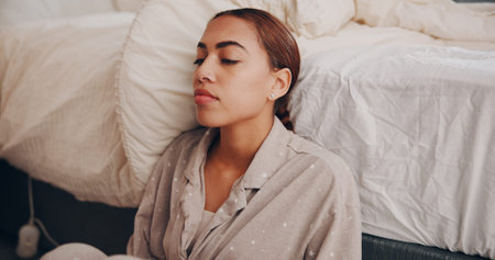 Woman, stress and insomnia by bed, thinking or reflection with mental health, depression or worry in...