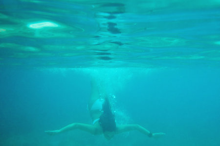 Woman, swimming and ocean for underwater tropical adventure, bikini for nature explore. Female...