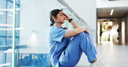 Nurse, woman and stress on hospital floor with healthcare crisis, medical mistake or treatment fail....