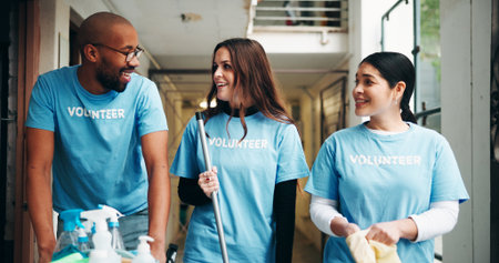 People, volunteer and supplies for cleaning, corridor maintenance and workplace hygiene. Happy, team and walking for hallway cleanliness, ngo briefing and sanitation project for social responsibilityの写真素材