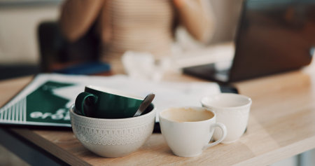 Dishes, mugs and bowl on desk in office for coffee, lunch break and eating with career. Business,...