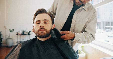 Hairdresser, barber and man with customer in chair for grooming, haircut and trim for beard service....