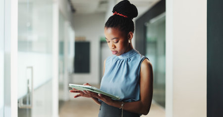 Tablet, professional and black woman in office with research for finance report for budget plan. Digital technology, reading and African female financial manager with email for investment proposal.の写真素材