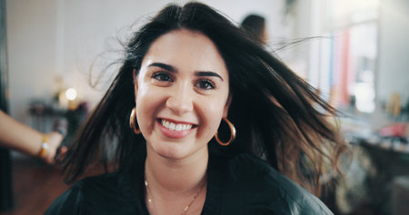 Portrait, smile and styling with woman at hairdresser for appointment, consulting or treatment. Satisfaction, service and volume with happy customer in hair salon for maintenance or restorationの写真素材