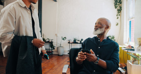 Man, hairdresser or customer with phone for service payment, banking or pos machine in salon. Male people, barber or client with mobile smartphone app for NFC choice or wireless transaction in parlorの写真素材