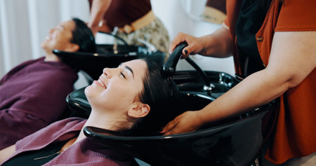 Hairdresser, customer or happy woman at wash basin in salon, professional service or clean scalp....