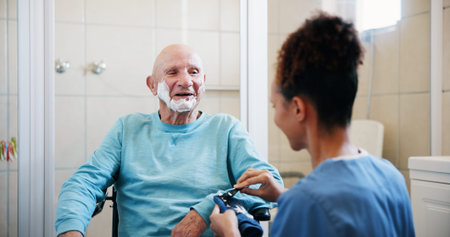 Senior man, nurse and shaving cream in bathroom with wheelchair, happy and talk with grooming in...