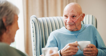 Conversation, couple and tea with senior man on oxygen for break, recovery or retirement. Breathing...