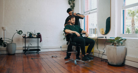 Consultation, blowdryer and barber with man in salon for haircut, maintenance or discussion. Appointment, grooming and male hairdresser with customer for trim, hairstyle or self care in parlor.の写真素材