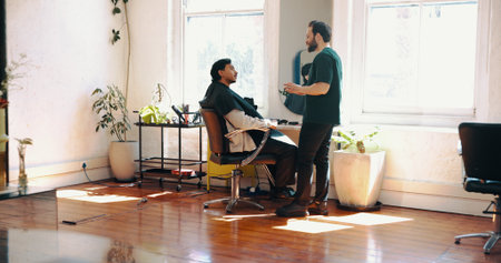 Man, barber and talk with client for hairstyle choice, offer and explain services at salon. People, hairdresser and discussion with decision for grooming, haircut or conversation at barbershopの写真素材