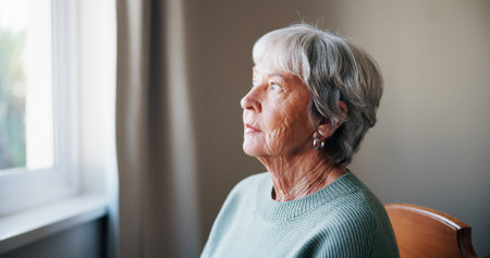 Thinking, remember and senior woman in home for memory, reflection or nostalgia with depression....