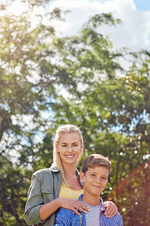 Portrait, mother or child in forest with smile, connection or bonding together on summer break. Happy, space or people in nature with trust, parent love or healthy relationship in spring getaway.の写真素材