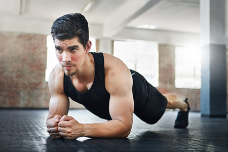 Fitness, man and plank workout at gym for core stability, muscle strength or endurance challenge....