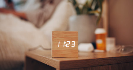 Digital alarm, time and bedroom in home for sleep schedule, person or rest for wellness. Electronics...