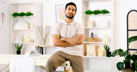 Portrait, man and physical therapist in office with confidence, wellness or medical service. Arms crossed, person and physiotherapist in health clinic for healing, chiropractor and professional prideの写真素材