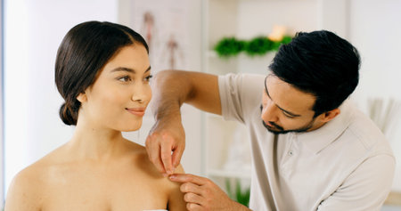 Smile, woman and needles for acupuncture at spa for muscle tension, natural pain relief and healing. Happy, people and physical therapy with traditional medicine, joint inflammation and dry needlingの写真素材
